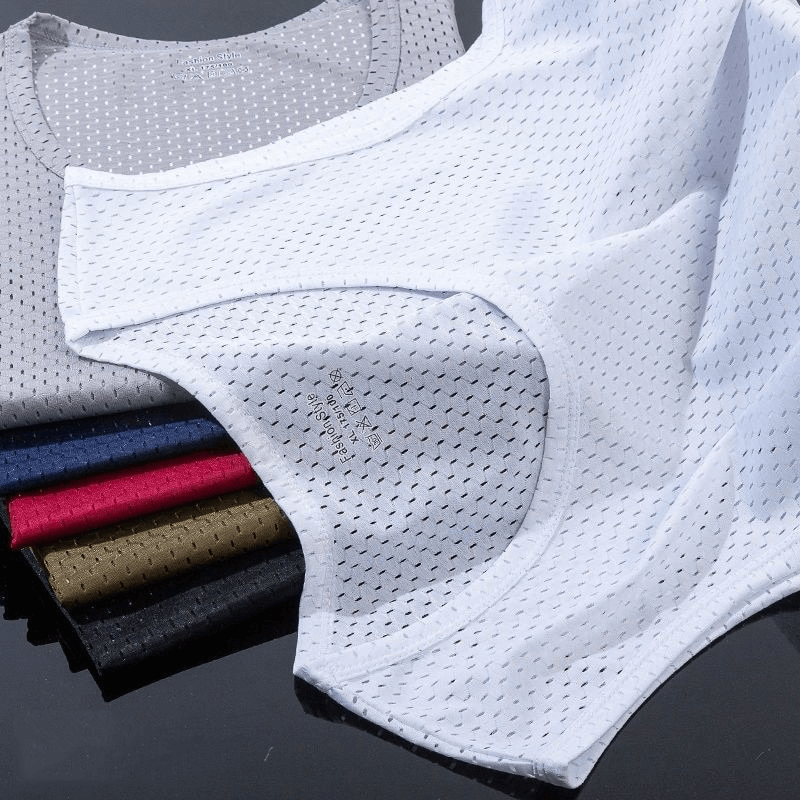 Breathable mesh tank tops in assorted colors for men, perfect for workouts and wrestling, displayed on a reflective surface.